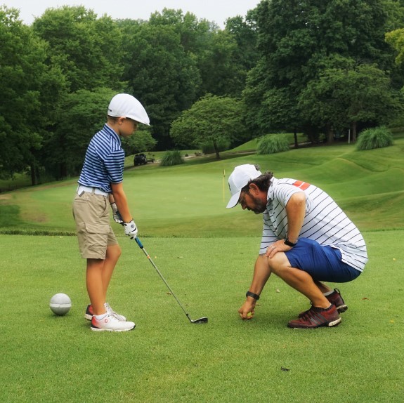 Parent and child golfing together